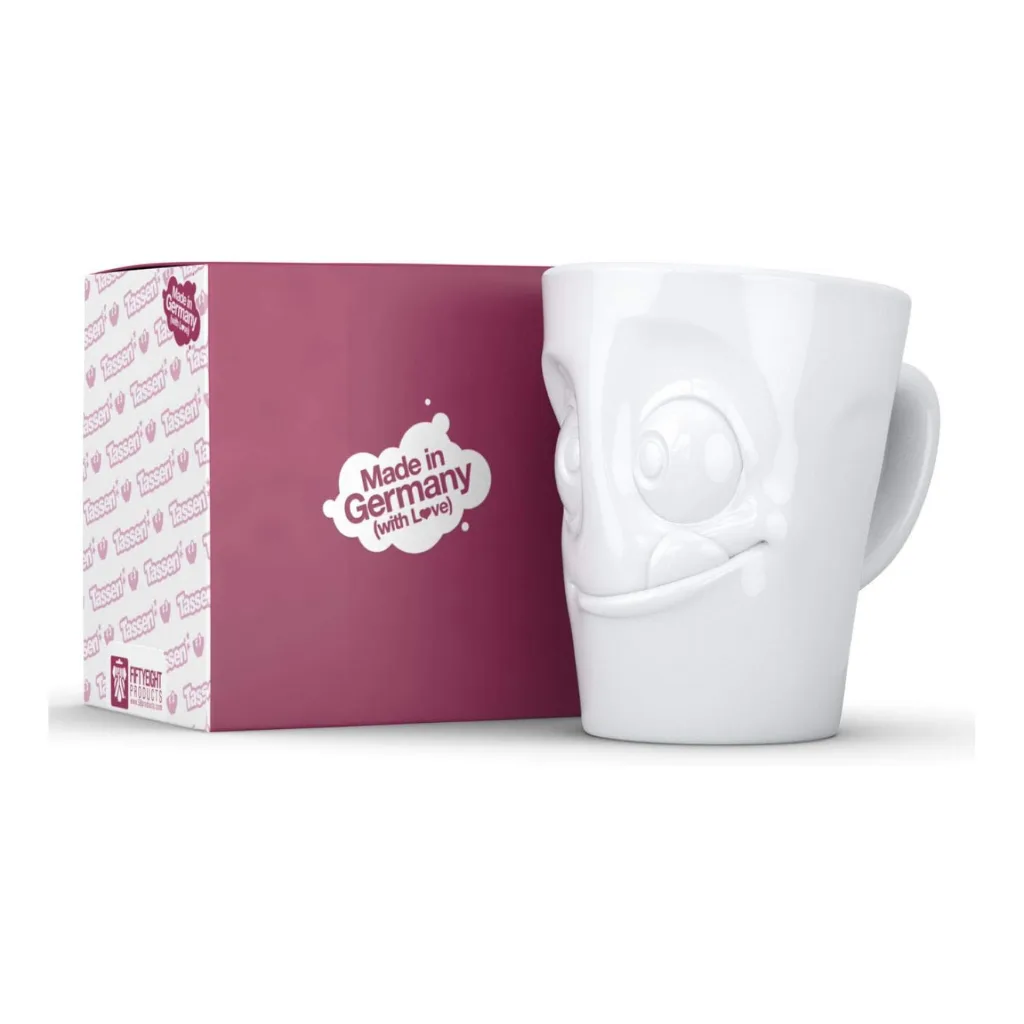 Mug avec anse affichant un visage gourmand et malicieux.