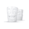 Set de deux mugs sans anse avec un visage hilare et un autre à l’expression gourmande, posés côte à côte.